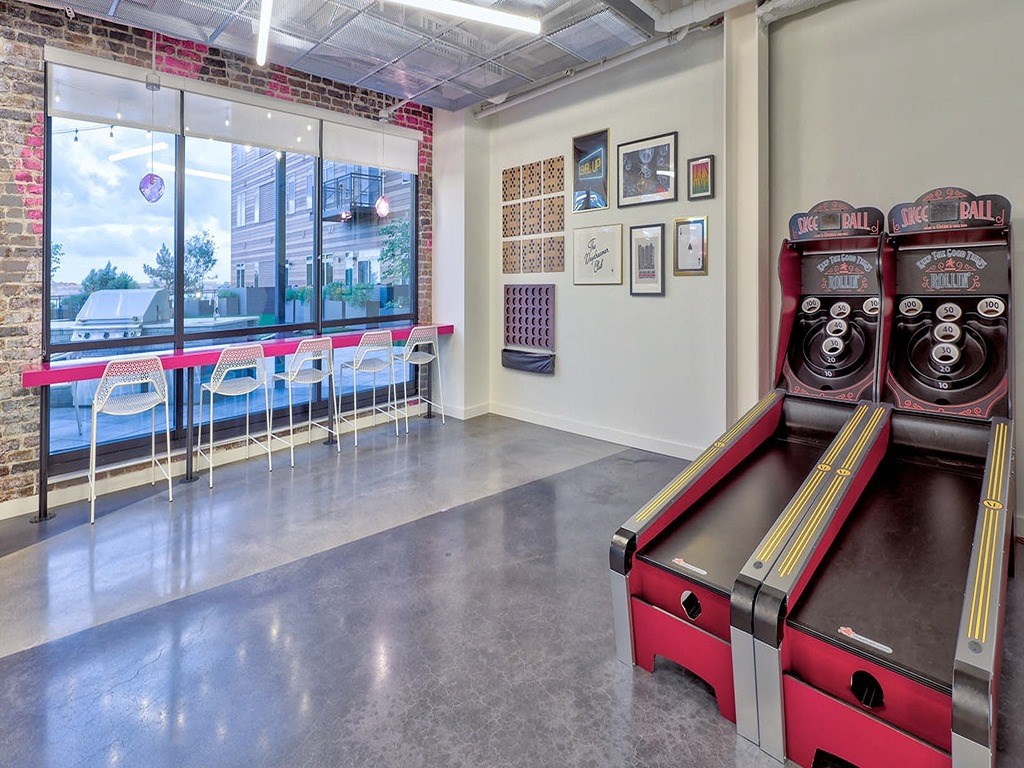 a game room with a coke machine and a window